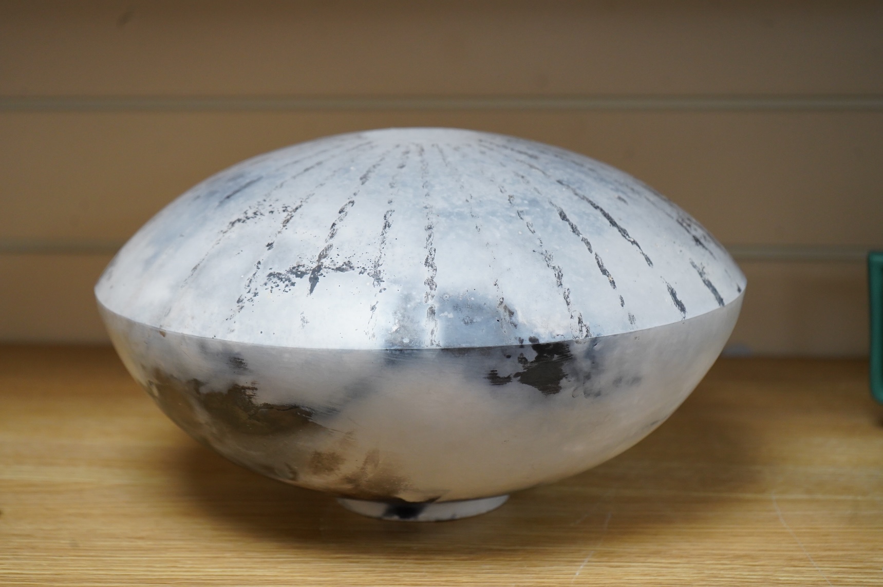 David Harrison (Modern British) a pit fired pottery vase of circular squat form, incised initials to the base, 31cm in diameter